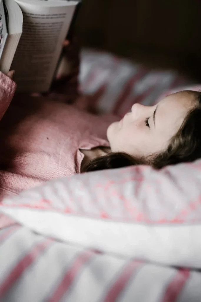 Child in bedroom reading in peace