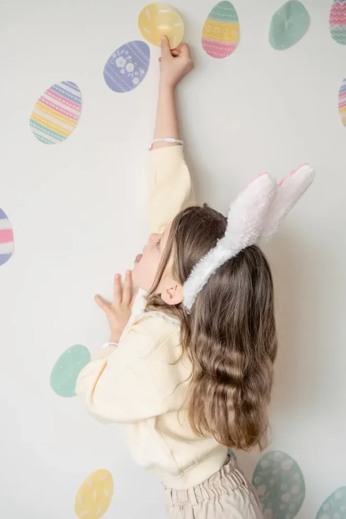 A child putting up wall decorations