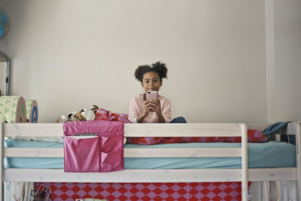 Child on a bunk bed. (Bunk bed Pros and Cons article)